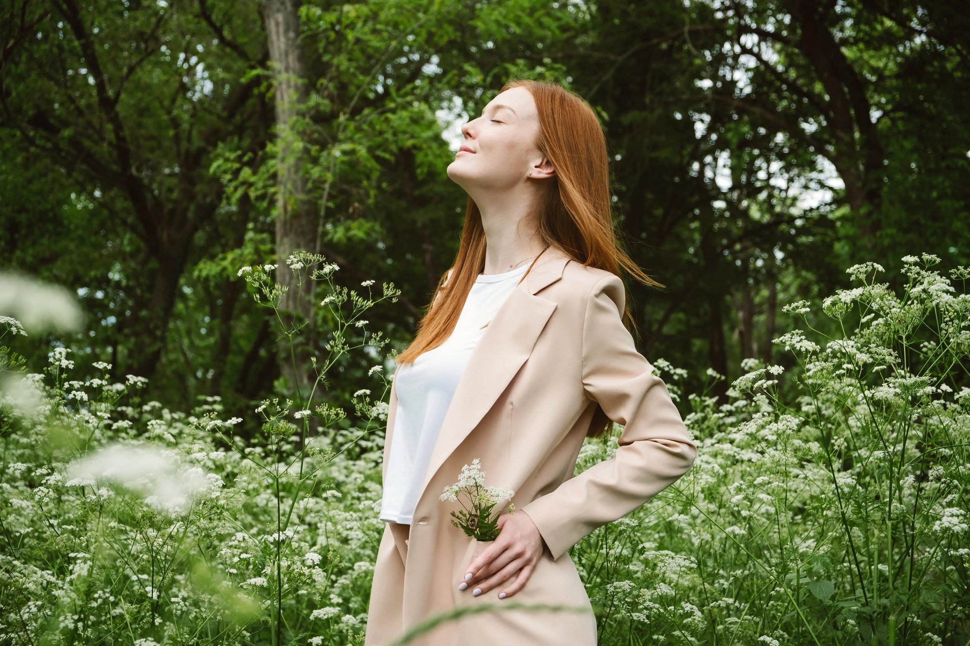 aesthetics_hormones_stress-free-life_wellness_redhead-woman-in-business-suit-enjoying-nature